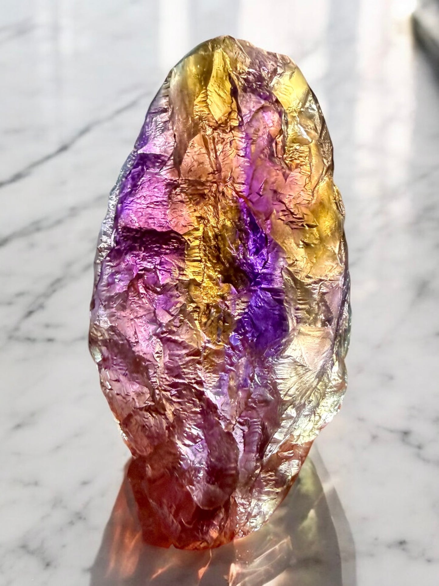 Natural Bolivian ametrine crystal with hydrothermal etching showing distinct purple amethyst and golden citrine color zoning