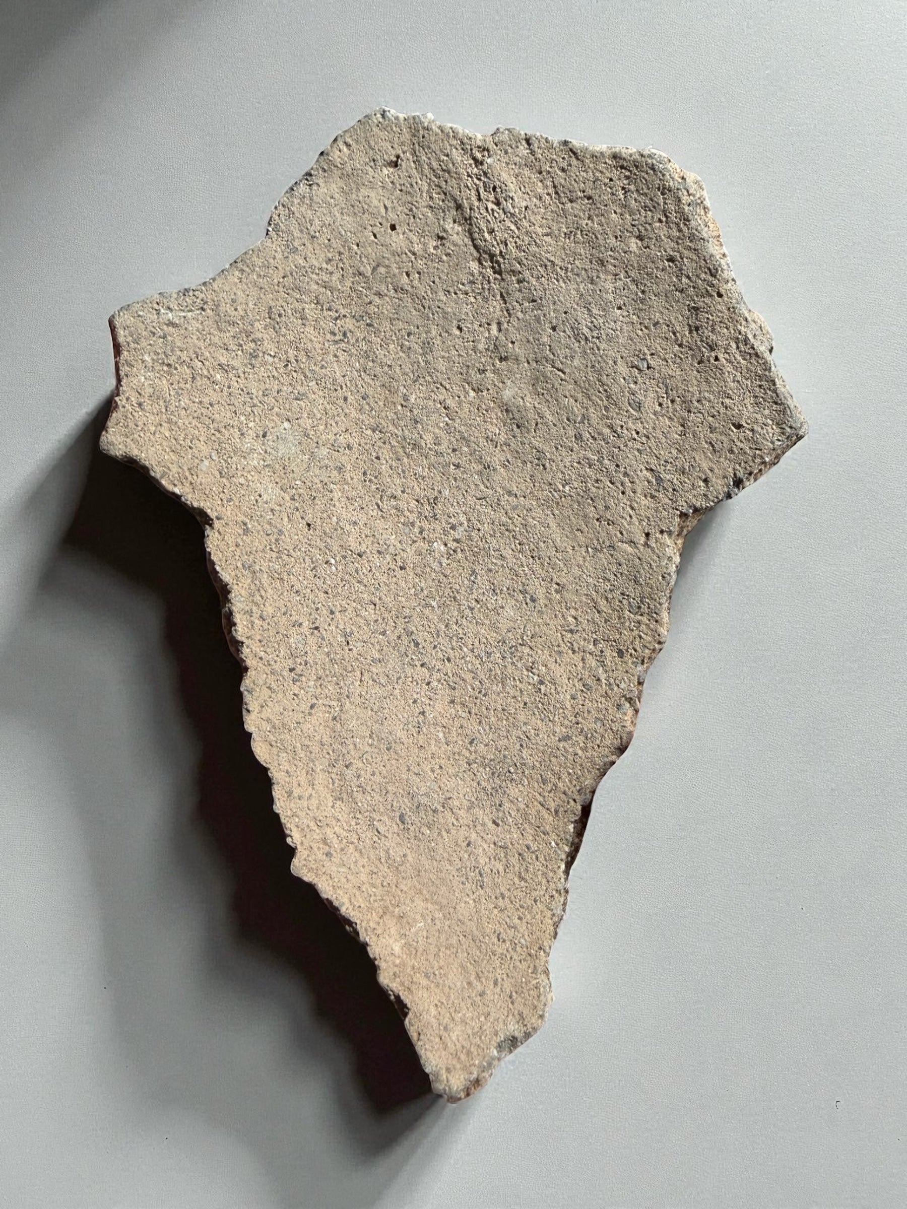 Historic Hohokam ceramic piece, archaeological pottery shard
Ancient pottery fragment with red-brown surface, Arizona artifact