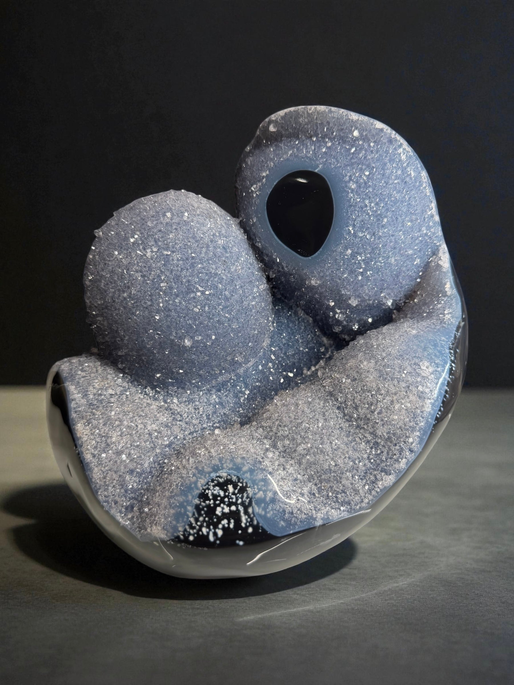 Natural blue agate from Artigas, Uruguay with two rounded druzy domes and a polished base, shown in bright lighting.