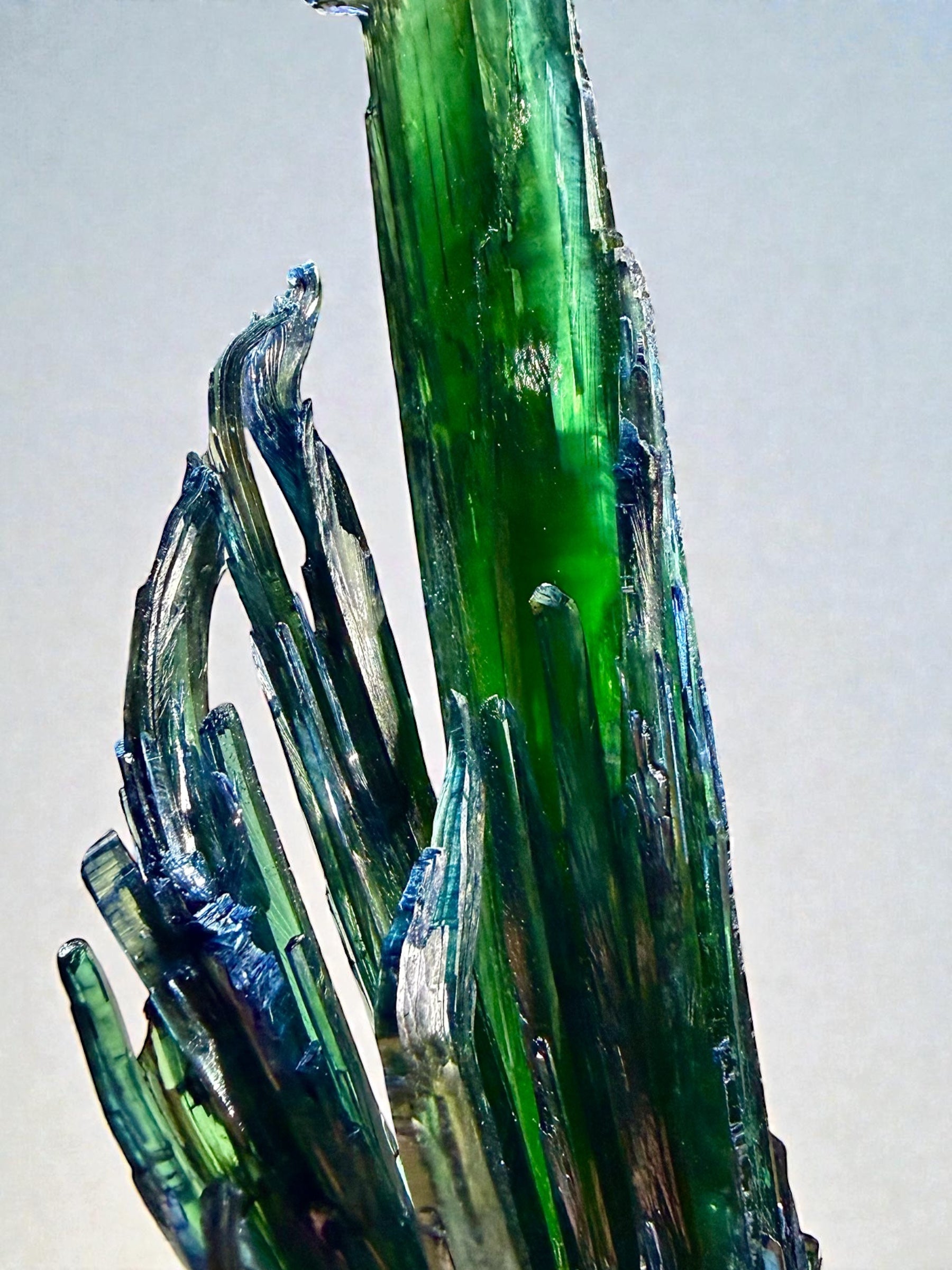 Close-up view of the double-terminated vivianite crystal highlighting clarity, tapering form, and naturally deformed tips.